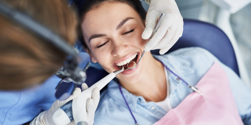 dentist inspecting a woman's mouth, endodontic treatment
