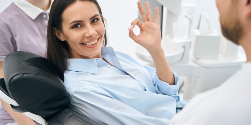 Positive woman client enjoying good service in private dental office
