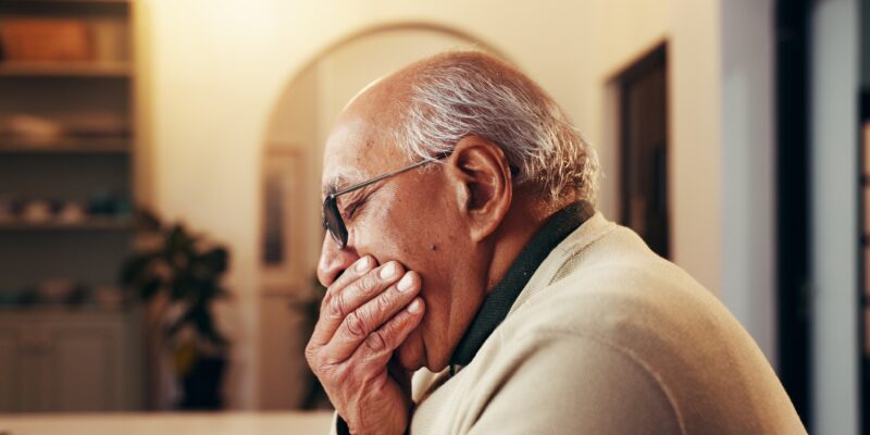 senior man holding his jaw, sensitive tooth, infection