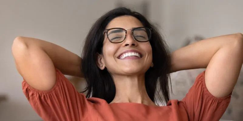 relaxed young woman, smiling in a dental chair