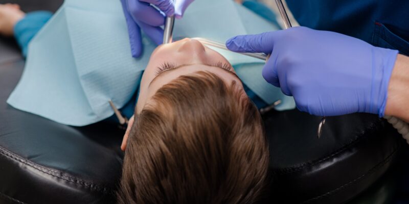 dentist checking young boys teeth