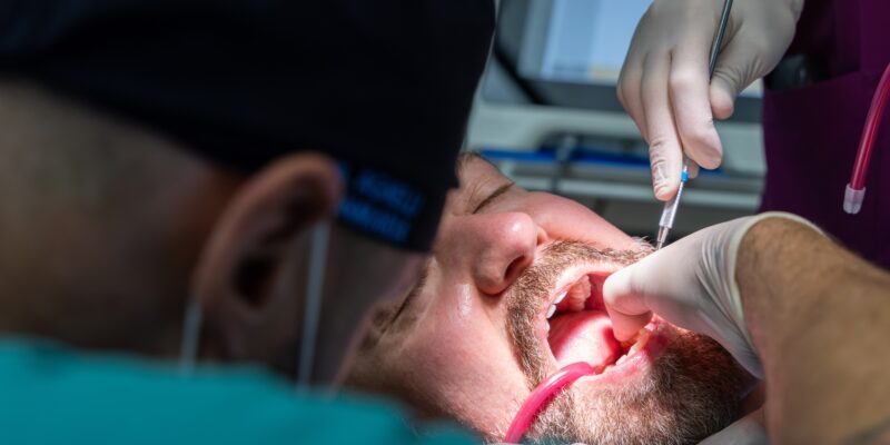 dentist performing an extraction on a patient